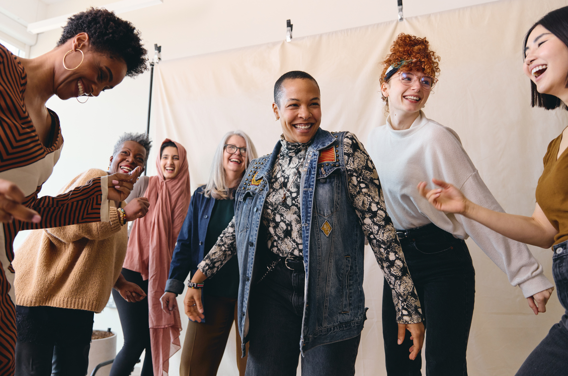 International Women's Day candid portrait of multi ethnic mixed age range women dancing